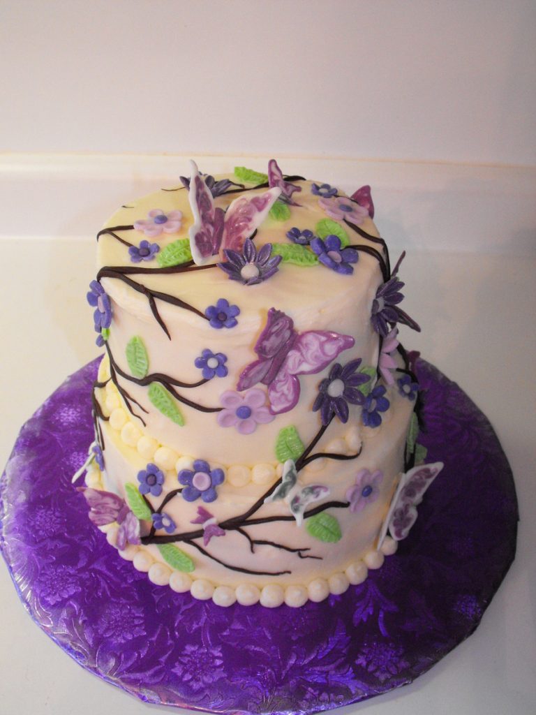 bolo decorado com flores e borboletas